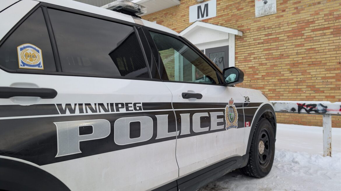 Winnipeg Police Service vehicle outside Blake Street apartment building in winter during homicide investigation
